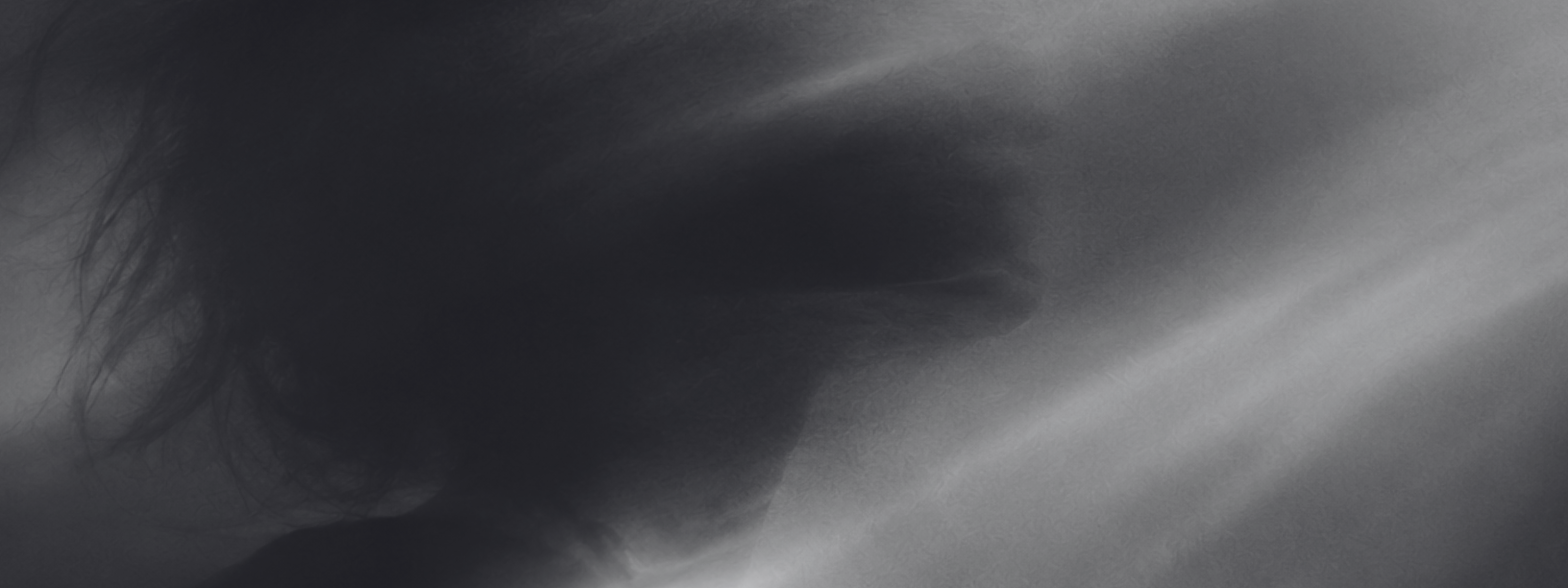 Aether Awareness banner showing a grayscale close-up of a human eye and face with layered shadow and light