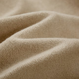 Close-up of the cream Soul Supremacy Snap Button Collar Hoodie Encoded Motifs showing the soft textured cotton fabric