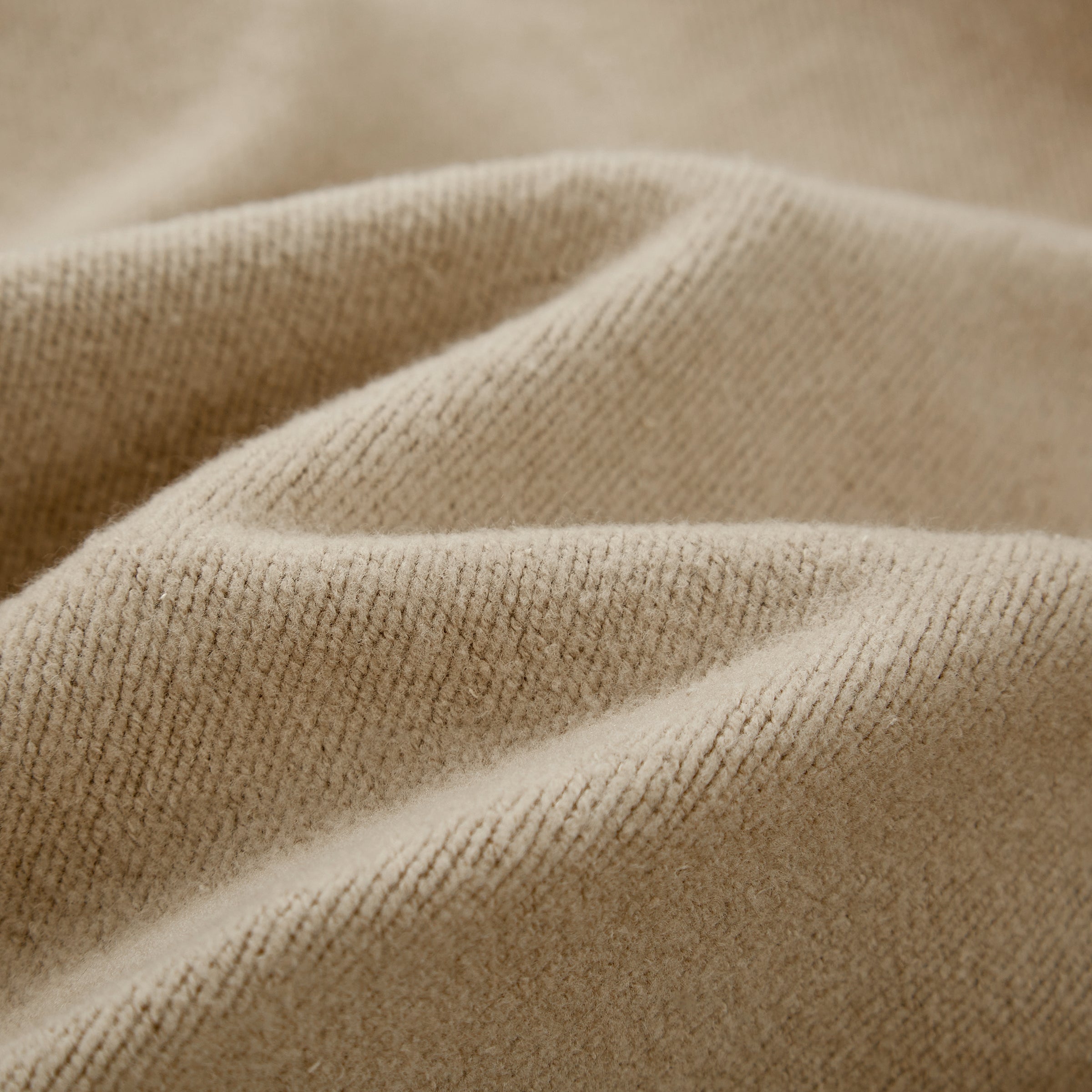 Close-up of the cream Soul Supremacy Snap Button Collar Hoodie Encoded Motifs showing the soft textured cotton fabric