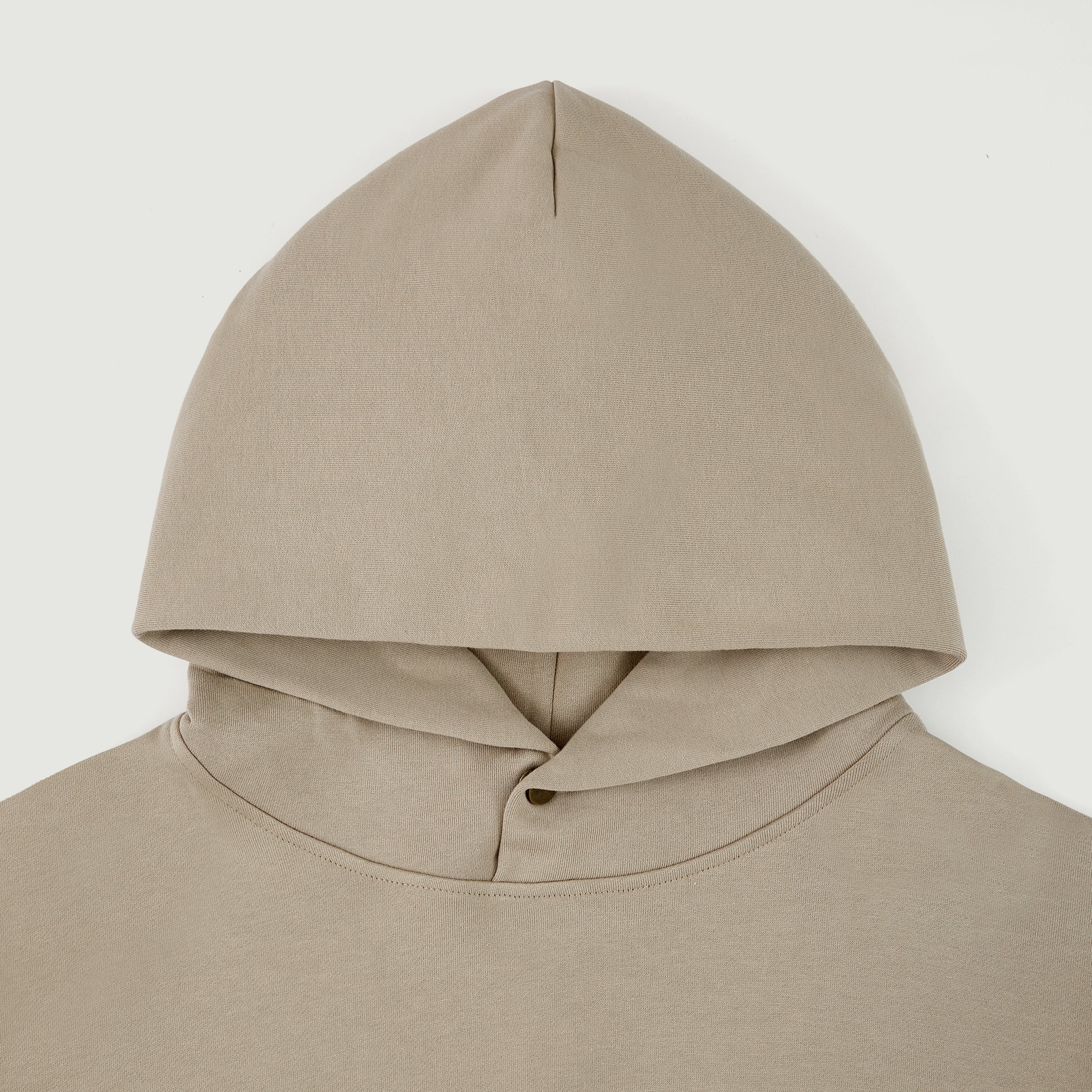 Top-half close-up of the cream Soul Supremacy Snap Button Collar Hoodie Encoded Motifs showing the hood and snap button collar detail