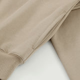 Close-up of the cream Soul Supremacy Snap Button Collar Hoodie Encoded Motifs showing the side pocket and washed fabric texture
