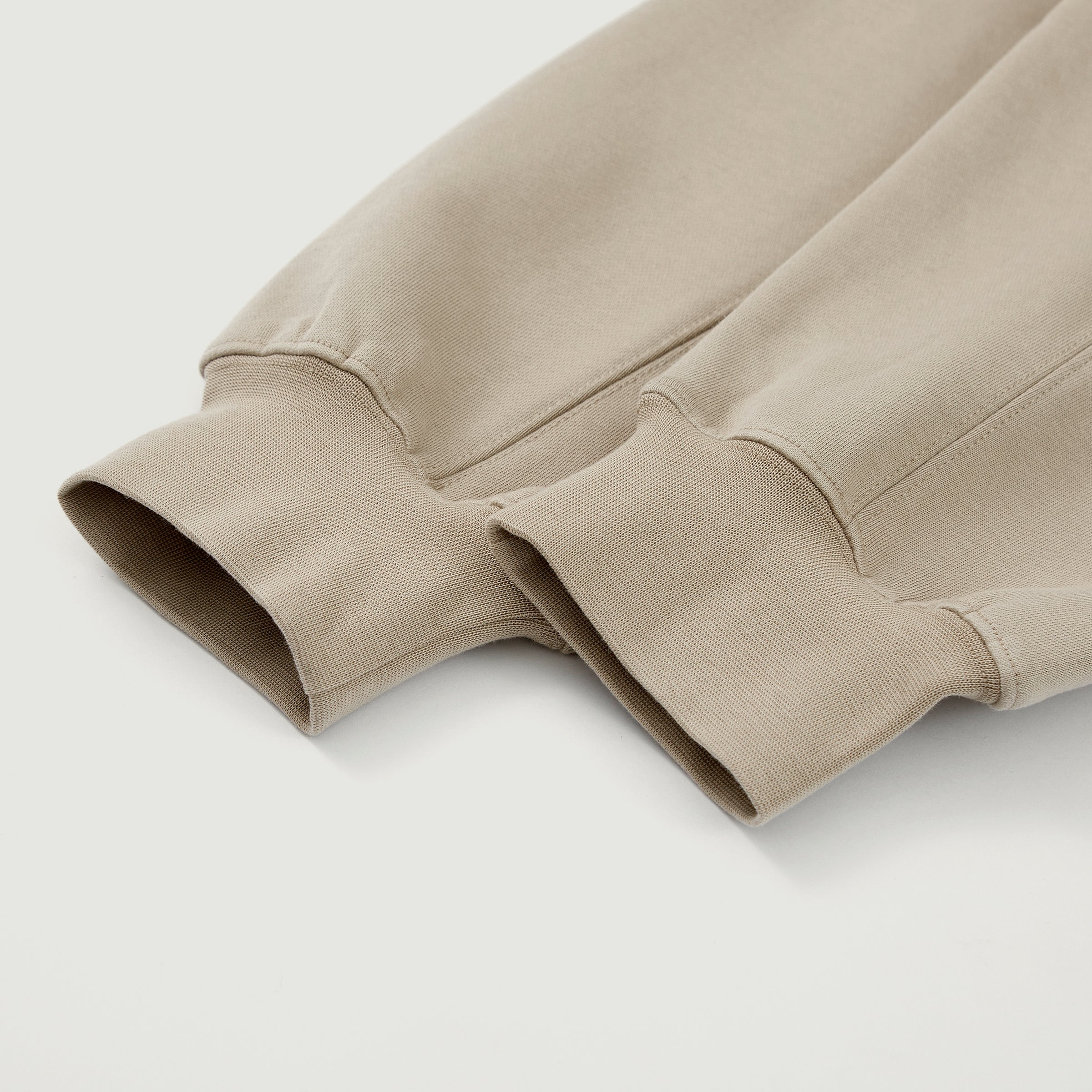 Close-up of the cream Soul Supremacy Snap Button Collar Hoodie Encoded Motifs sleeves